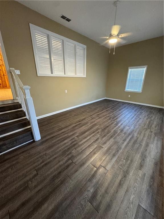 empty room featuring ceiling fan and dark hardwood / wood-style flooring