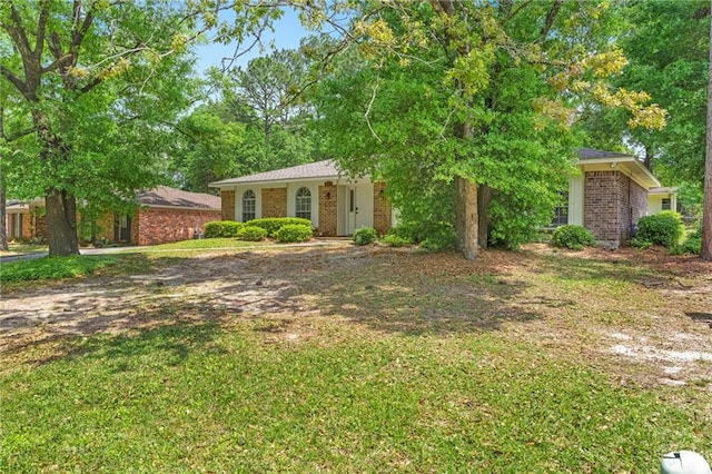 ranch-style home with a front lawn and brick siding