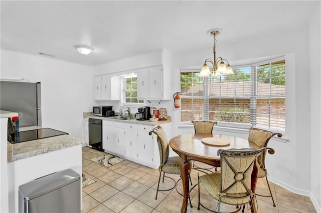 kitchen with light countertops, visible vents, light tile patterned floors, a sink, and appliances with stainless steel finishes