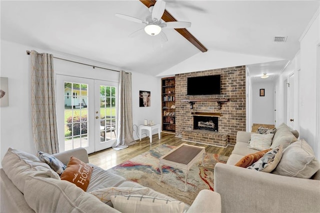 living area featuring lofted ceiling with beams, french doors, visible vents, a ceiling fan, and wood finished floors