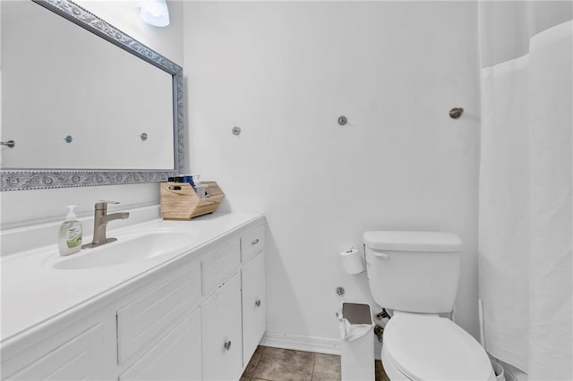 full bathroom featuring tile patterned flooring, toilet, vanity, and baseboards