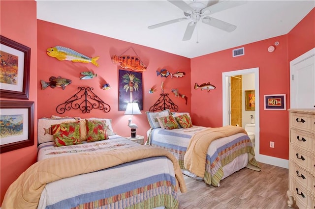 bedroom with connected bathroom, light wood-type flooring, and ceiling fan