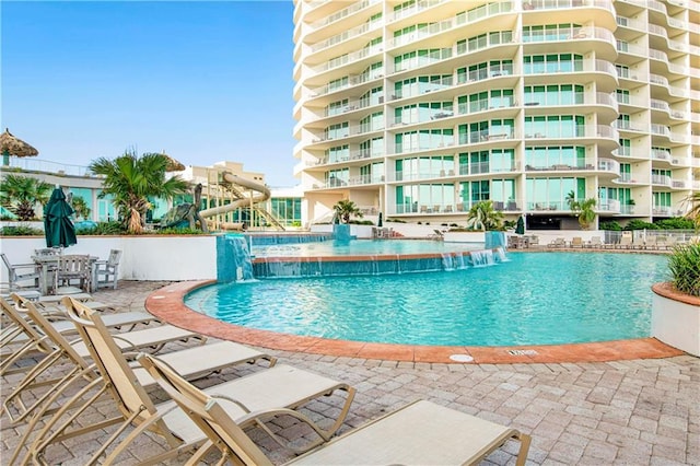 view of pool with a patio and pool water feature