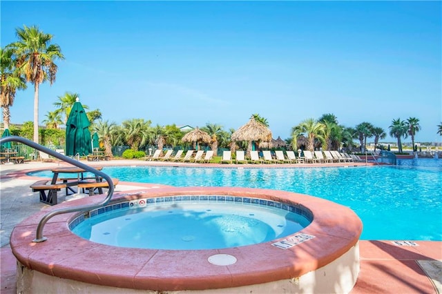 view of swimming pool with a community hot tub