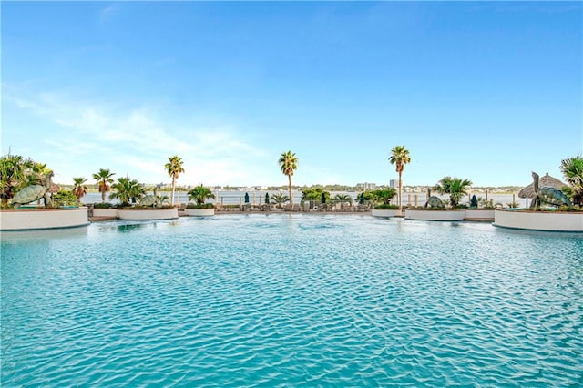 view of pool with a water view