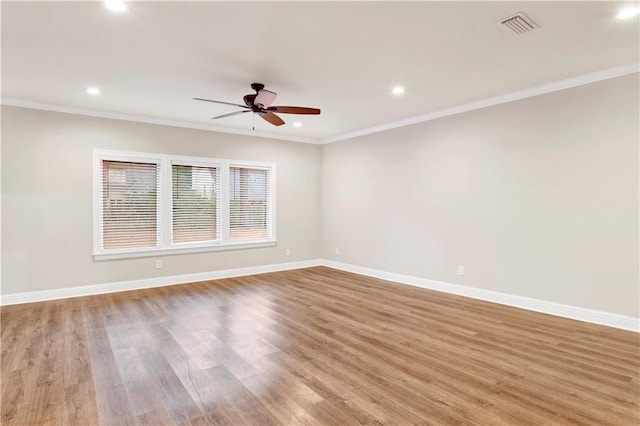 spare room featuring crown molding, ceiling fan, and light hardwood / wood-style flooring