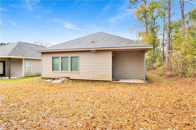 rear view of property featuring a yard