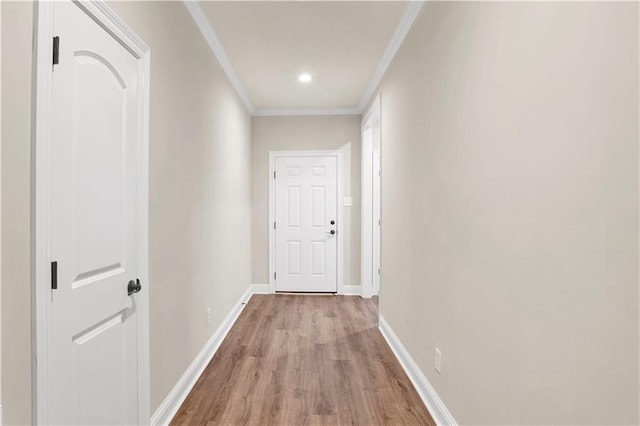 corridor with crown molding and light hardwood / wood-style floors