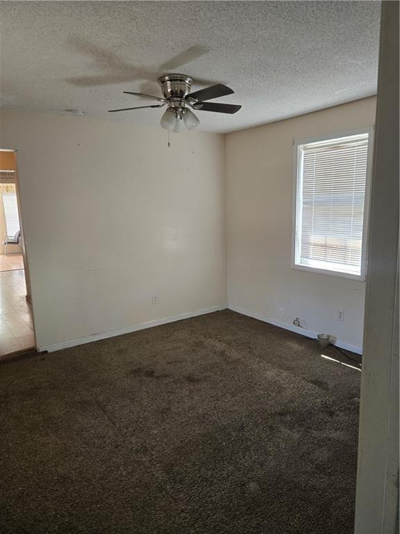 724 Half Ave, Mobile, AL 36610 - unfurnished room featuring carpet flooring, a textured ceiling, baseboards, and ceiling fan