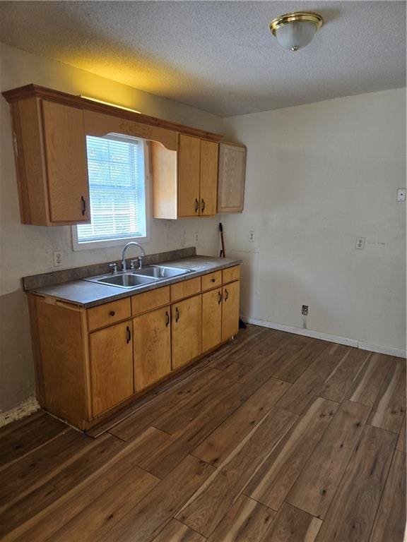 724 Half Ave, Mobile, AL 36610 - kitchen with dark wood finished floors, a sink, and a textured ceiling