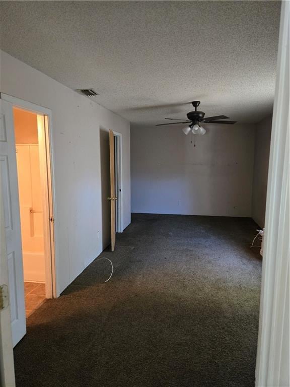 724 Half Ave, Mobile, AL 36610 - spare room featuring dark colored carpet, ceiling fan, and a textured ceiling