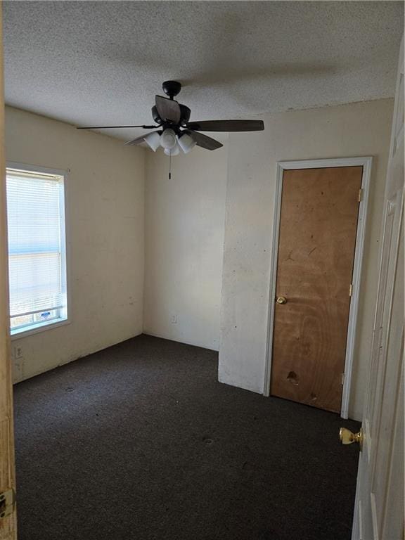 724 Half Ave, Mobile, AL 36610 - spare room featuring a ceiling fan, dark colored carpet, and a textured ceiling