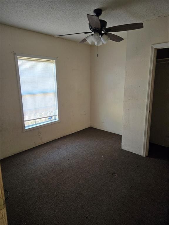 724 Half Ave, Mobile, AL 36610 - spare room with a ceiling fan, dark colored carpet, and a textured ceiling