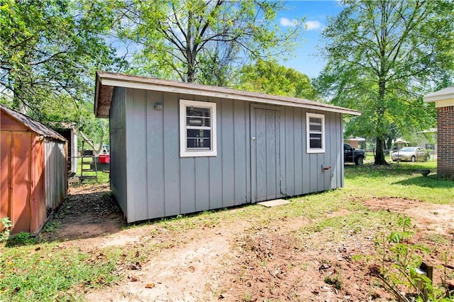 view of shed featuring fence