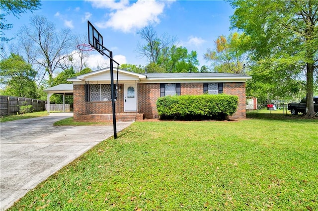 single story home with concrete driveway, an attached carport, fence, brick siding, and a front lawn