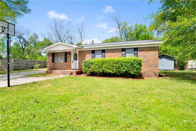 single story home with brick siding, a front yard, and fence
