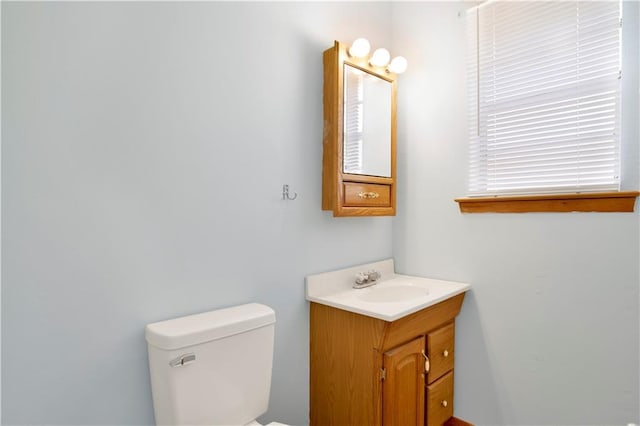 half bath featuring toilet and vanity