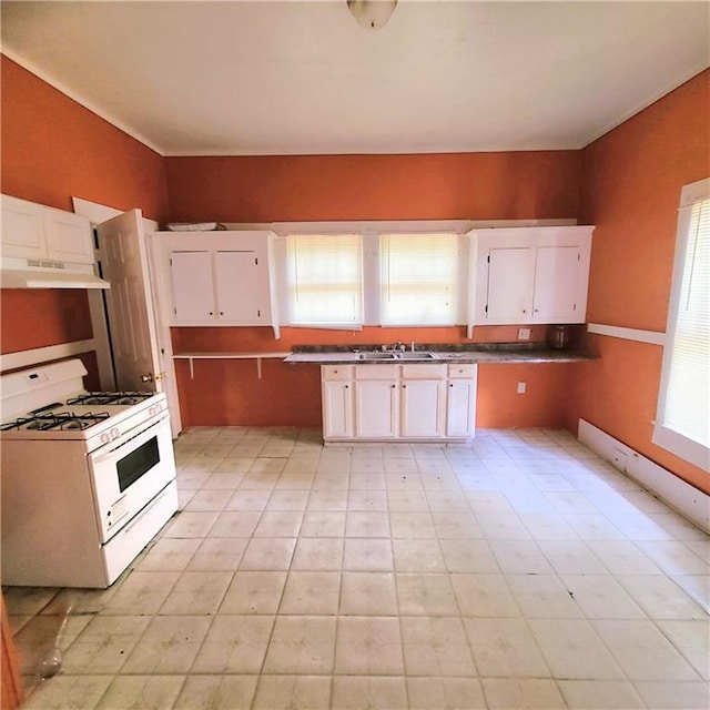 kitchen featuring sink, white cabinetry, and white gas range oven