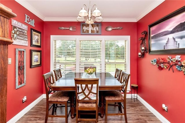 dining area with ornamental molding, a chandelier, baseboards, and wood finished floors