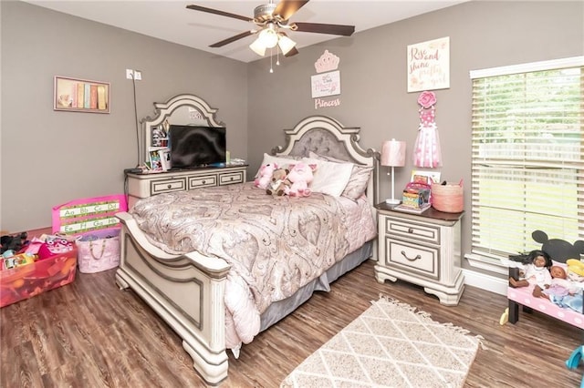 bedroom with multiple windows, a ceiling fan, and wood finished floors