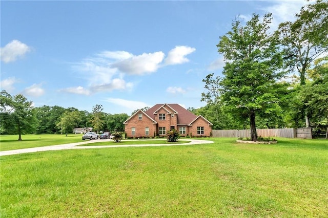 view of front of house with a front lawn and fence