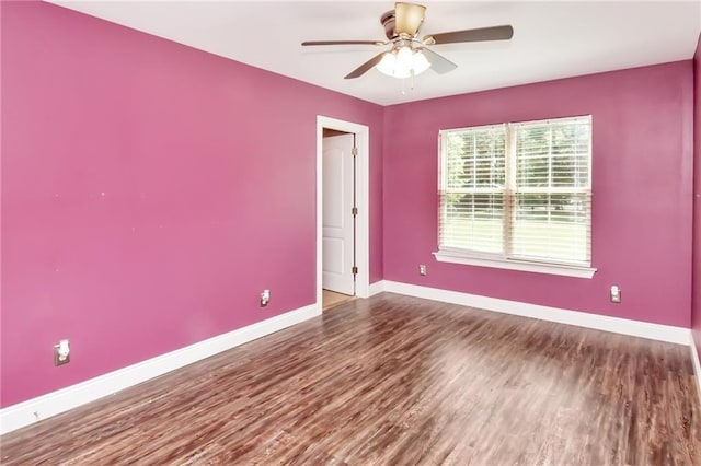 unfurnished room with a ceiling fan, baseboards, and wood finished floors