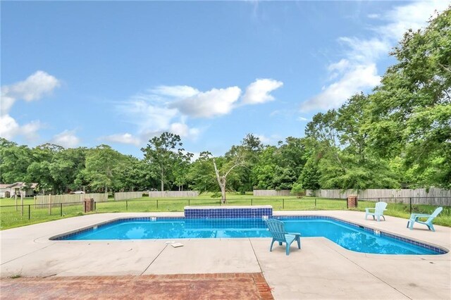 view of swimming pool featuring a patio, a lawn, fence, and a fenced in pool