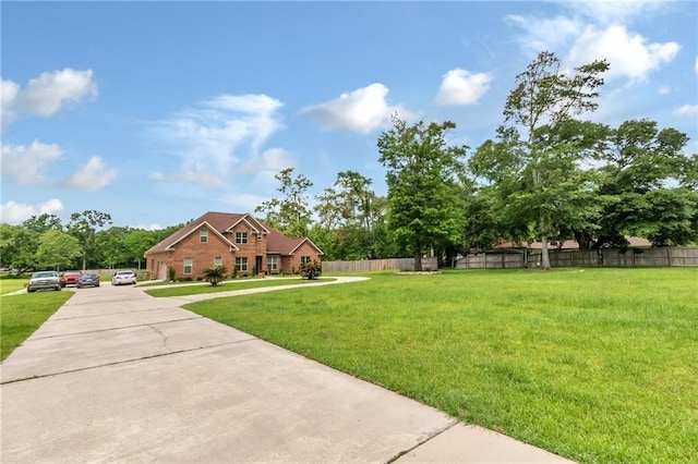 exterior space featuring a front lawn and fence