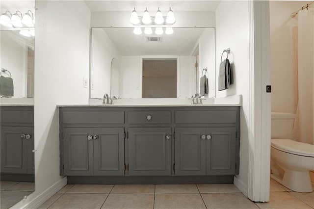 bathroom with tile patterned floors, vanity, and toilet