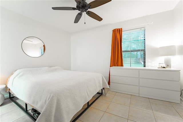 bedroom with ceiling fan and light tile patterned floors