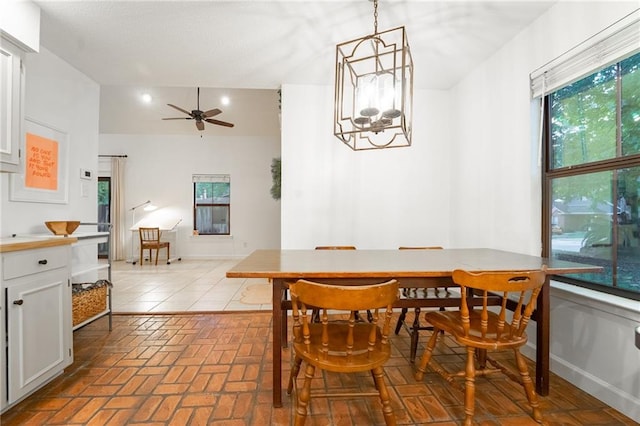 dining area with ceiling fan with notable chandelier