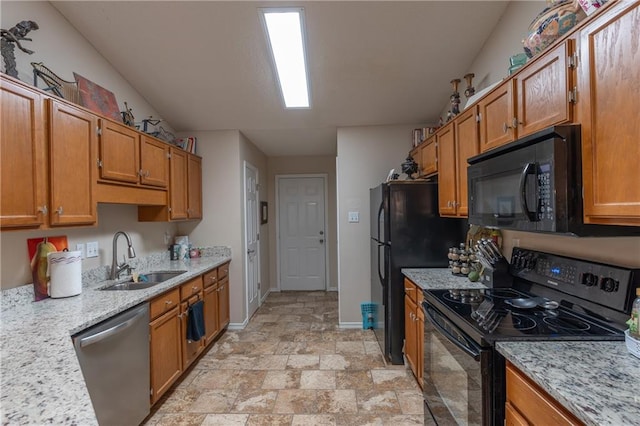 629 Spring Lake Dr W, Mobile, AL 36695 - kitchen with black appliances, brown cabinetry, light stone finish floors, and light stone counters