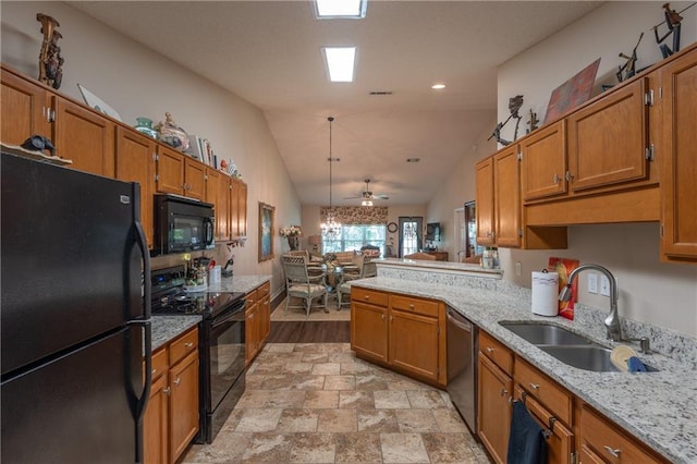 629 Spring Lake Dr W, Mobile, AL 36695 - kitchen featuring black appliances, brown cabinets, a peninsula, and vaulted ceiling