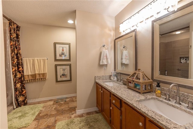 629 Spring Lake Dr W, Mobile, AL 36695 - bathroom with double vanity, a textured ceiling, a shower with shower curtain, recessed lighting, and stone finish floors