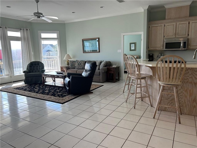 tiled living room with ceiling fan and ornamental molding