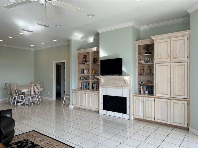 tiled living room with a tiled fireplace and ornamental molding