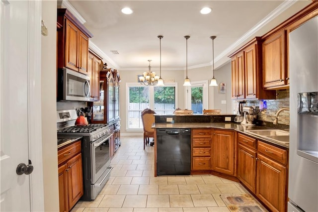 kitchen with sink, decorative light fixtures, ornamental molding, kitchen peninsula, and stainless steel appliances