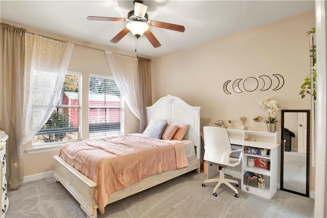 bedroom featuring light carpet and ceiling fan