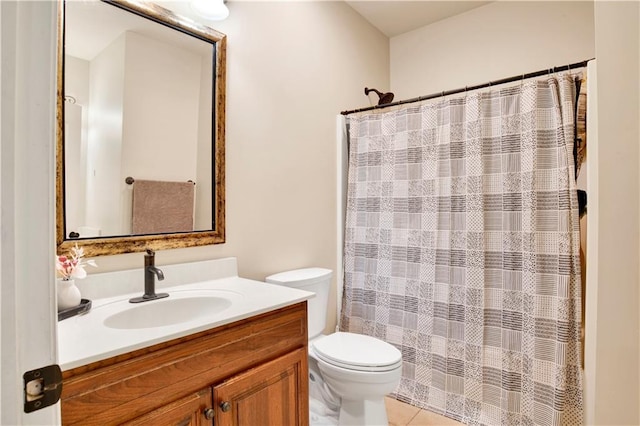 bathroom with tile patterned floors, vanity, toilet, and curtained shower