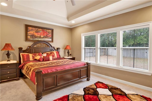 bedroom with crown molding, light colored carpet, a raised ceiling, and ceiling fan