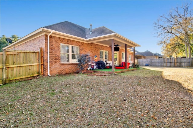 back of property with a patio area and ceiling fan