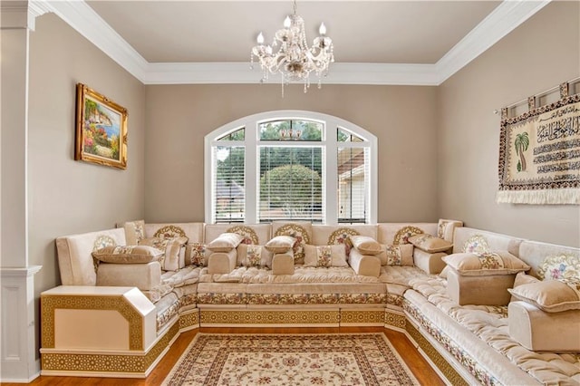 sitting room featuring crown molding, a chandelier, and hardwood / wood-style flooring