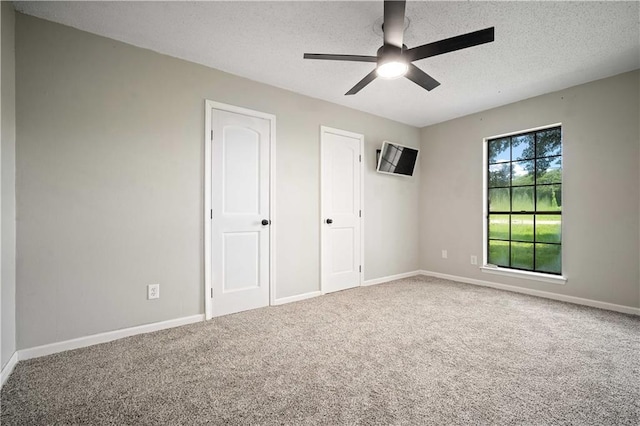 8500 Cindy Lou Dr, Theodore, AL 36582 - unfurnished bedroom with a textured ceiling, carpet, and ceiling fan