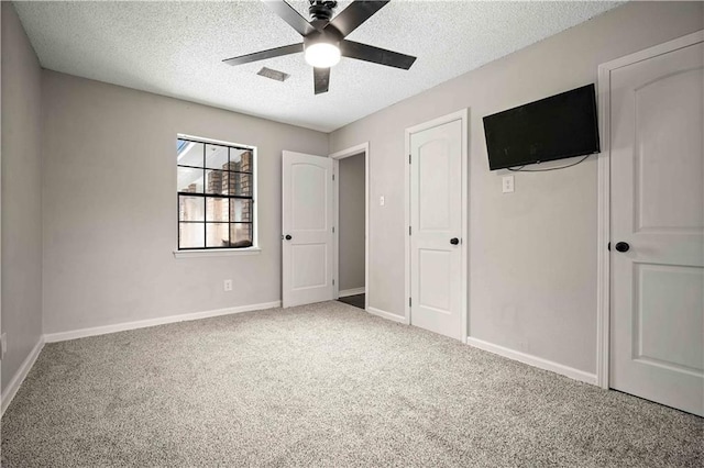 8500 Cindy Lou Dr, Theodore, AL 36582 - unfurnished bedroom with carpet floors, a textured ceiling, and ceiling fan