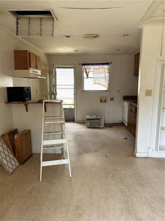 kitchen with a kitchen bar, kitchen peninsula, and white dishwasher