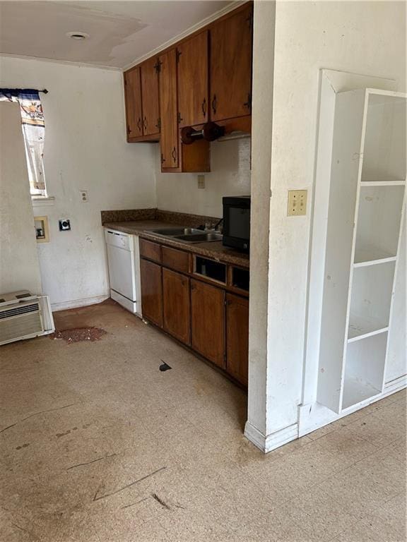 kitchen with an AC wall unit, sink, and white dishwasher