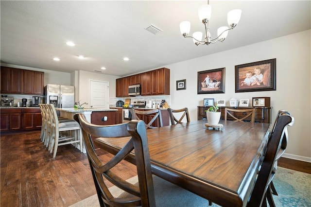 dining space featuring a chandelier and dark hardwood / wood-style flooring