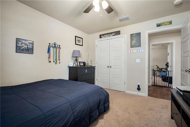 carpeted bedroom featuring a closet and ceiling fan