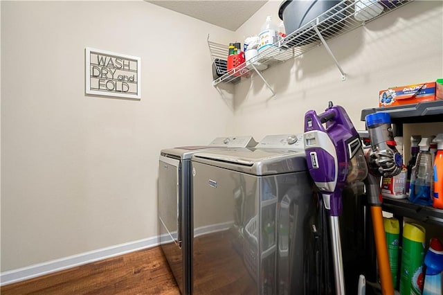 laundry room with separate washer and dryer and dark wood-type flooring