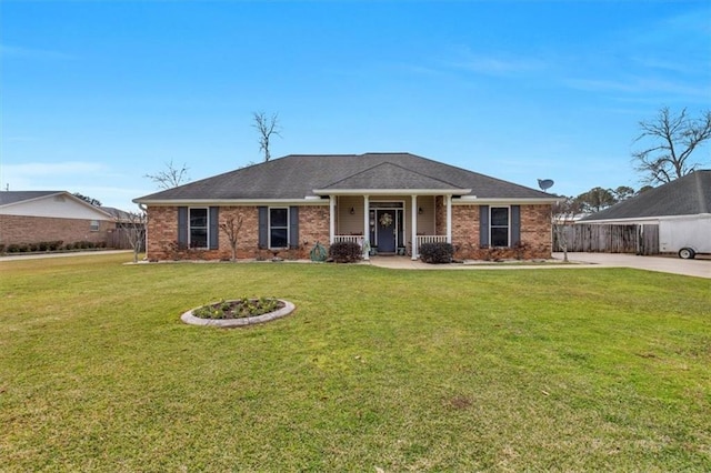 single story home featuring brick siding, a front yard, and fence